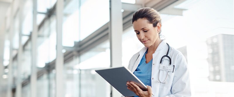 Doctor looking at digital tablet