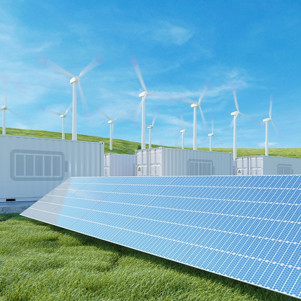 Solar panels in front of a wind farm