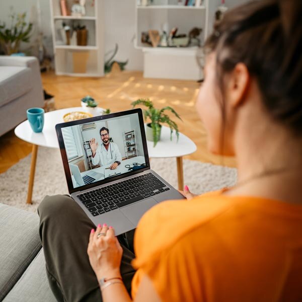 Woman sitting with laptop on her lap