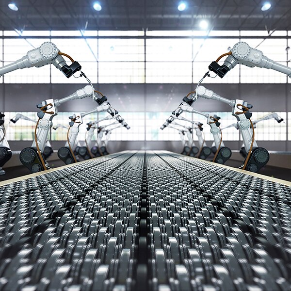 Robotic arm and steel conveyor in assembly manufacturing factory.