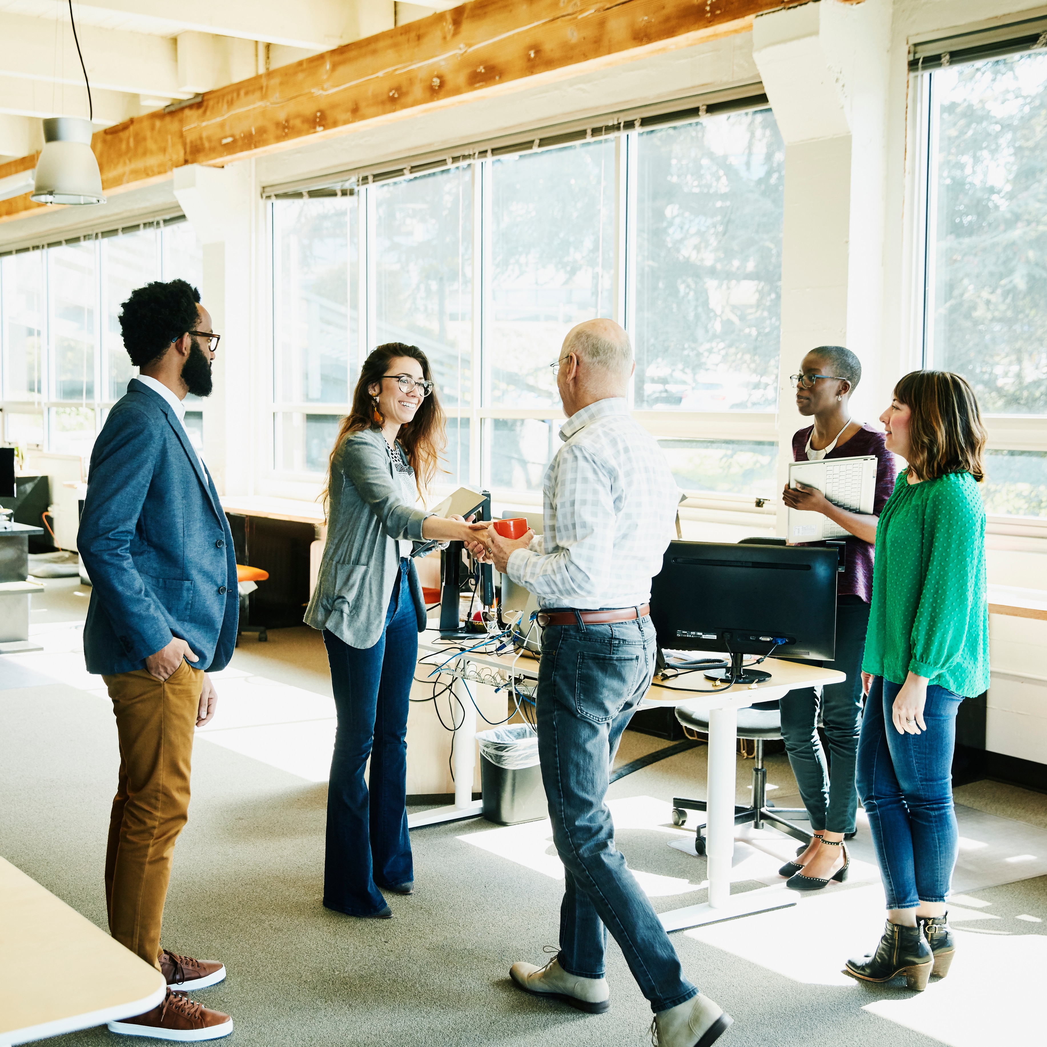 Businesswoman shaking handing with client before meeting in start up office