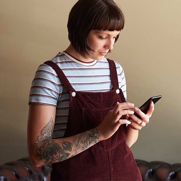 Young woman using mobile banking app