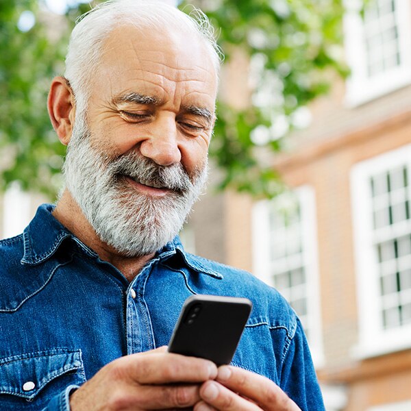 older man looking at phone