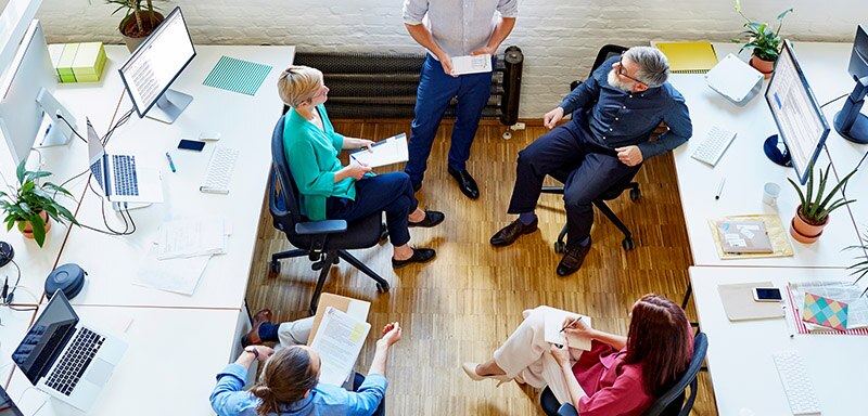 Business people sitting in chairs talking