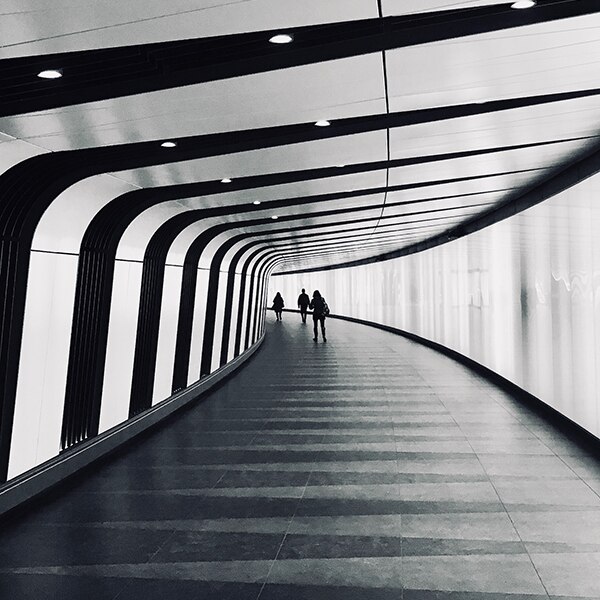 Modern hallway with people walking in the distance.