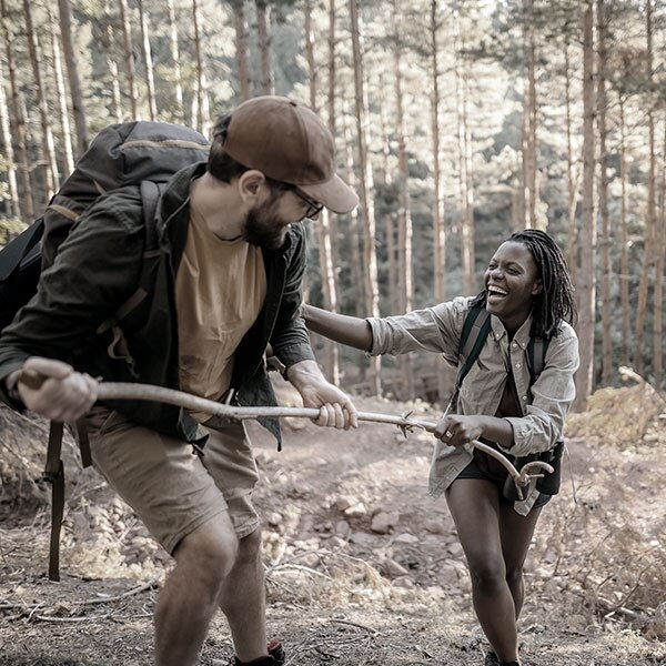 Couple hiking in wood laughing