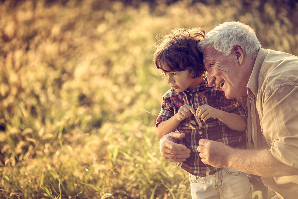 A grandfather and grandson enjoying nature in the autumn